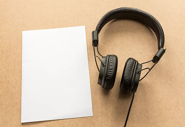 istock Headphone with white paper note on wood desk. 603199020