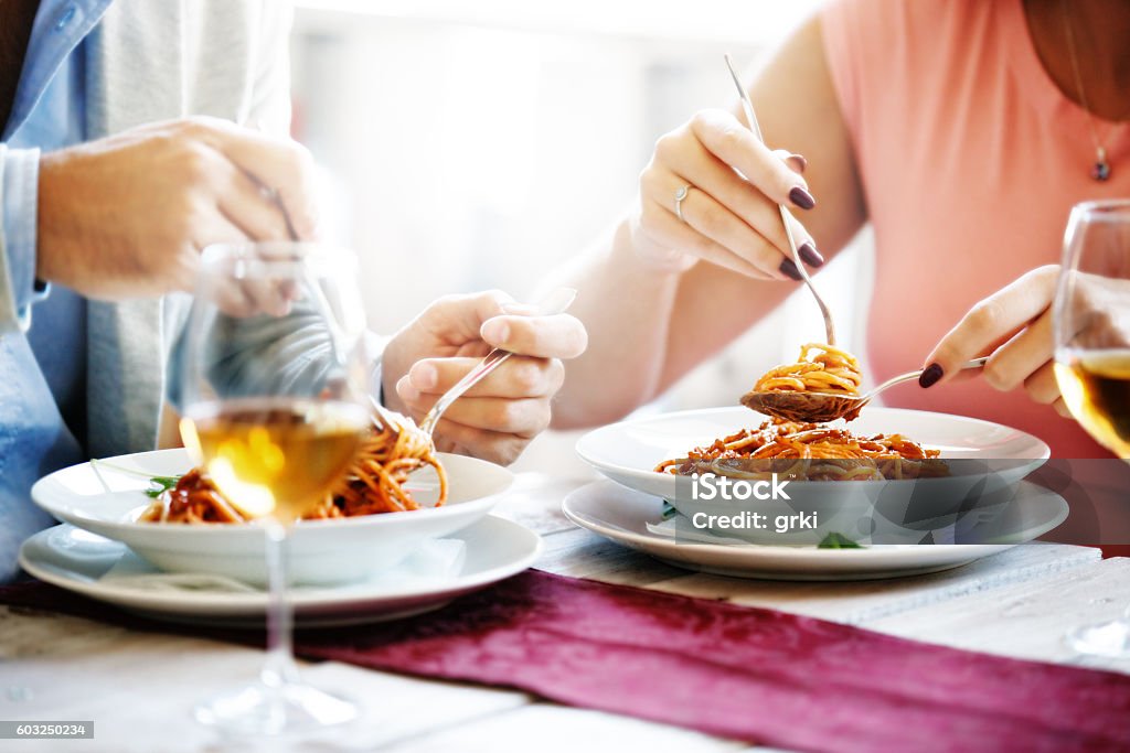 Eating Spaghetti Couple in a reastaurant. Close up concept. Restaurant Stock Photo