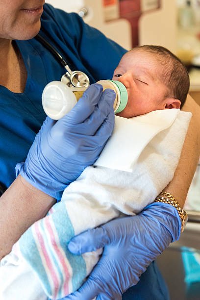 istock Female Nurse feeding a newborn 603251140