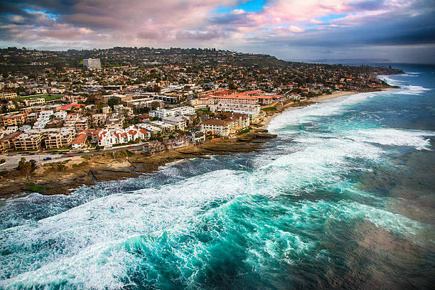 Rocky Shoreline of La Jolla California From Above The town of La Jolla within the city of San Diego, California, sitting on rocky cliffs along the Pacific Ocean shot near dusk as a storm was clearing from a helicopter.   la jolla stock pictures, royalty-free photos & images