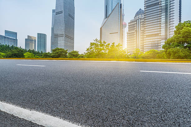istock clean asphalt road with city skyline background 603251816