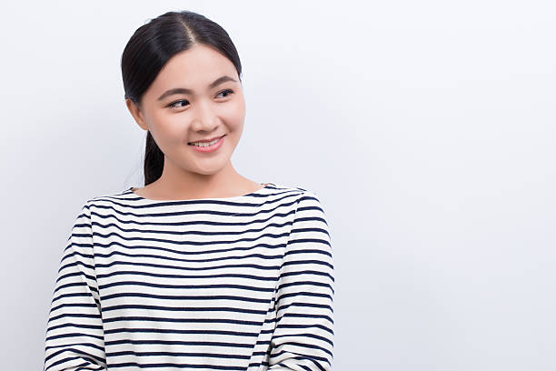 istock Asian woman thinking and happy isolated on white background 603251966