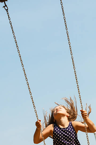 istock Playful crazy girl on swing. 603254664