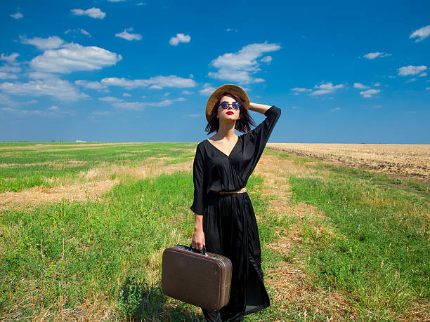 istock young woman with suitcase 603254826