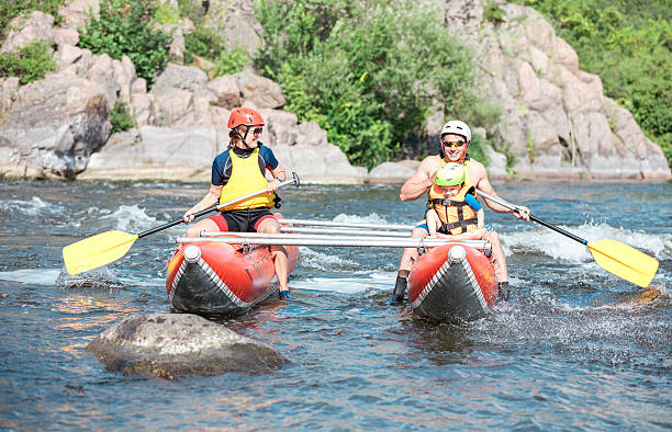 istock Young couple with a little son rowing up the stream 603260510