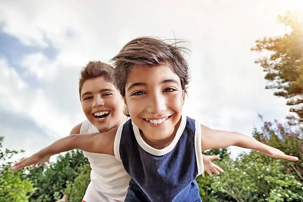 Photo of Happy brothers playing outdoors