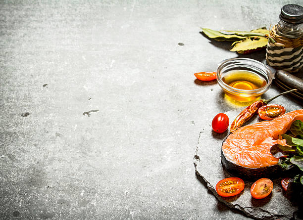 istock piece of raw trout and tomatoes. 603261252