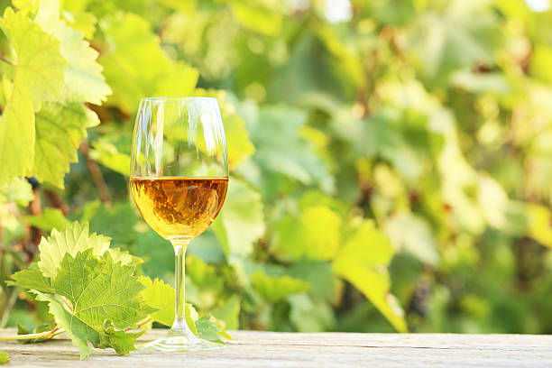 istock Wine in glass on grey wooden table 603261340