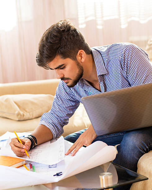 Young male student working at home.