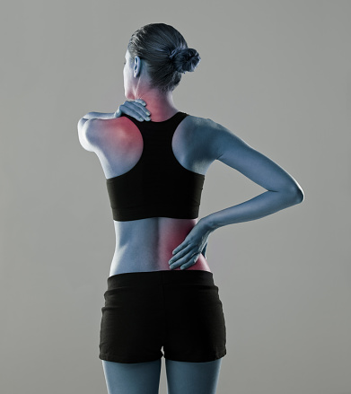 Studio shot of an athlete with an injury highlighted in glowing red