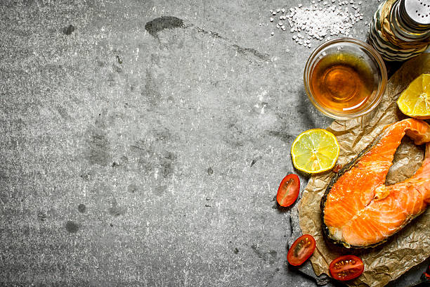 istock Grilled salmon with olive oil, tomatoes, lemon and spices. 603262342