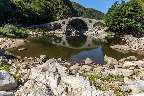 istock Reflection of Devil's Bridge and Rhodopes mountain in Arda river 603262468