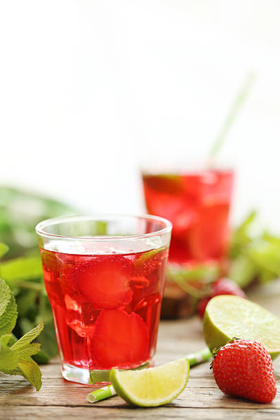 istock Fresh strawberry drink in glass with lime on wooden table 603263298