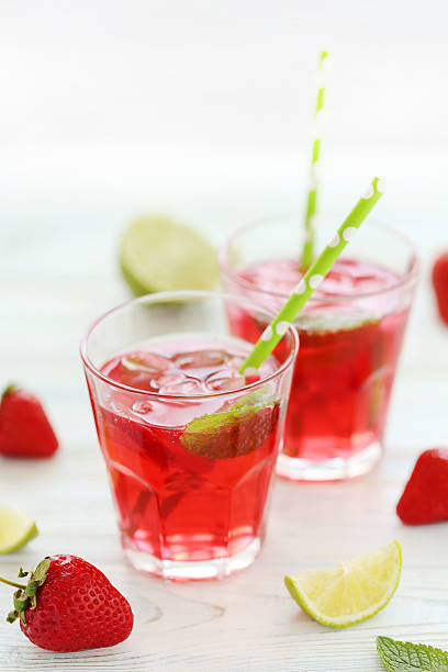 istock Fresh strawberry drink in glass with lime on wooden table 603263354