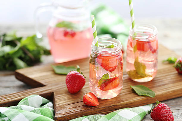 istock Fresh strawberry drink in bottle on wooden table 603263402