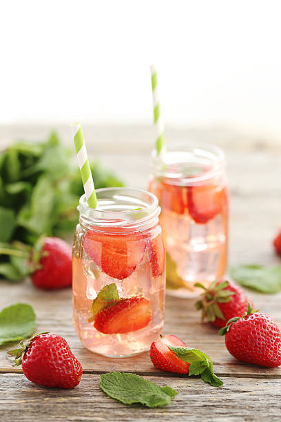 istock Fresh strawberry drink in bottle on wooden table 603263446