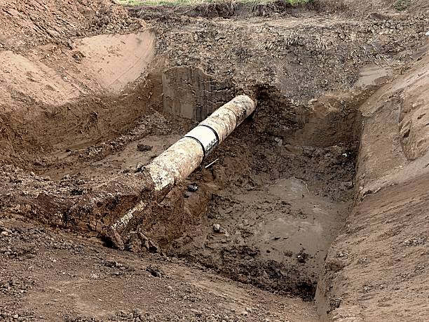 istock Excavation pit. Old drink water pipe with  stainless sleeve members 603263908