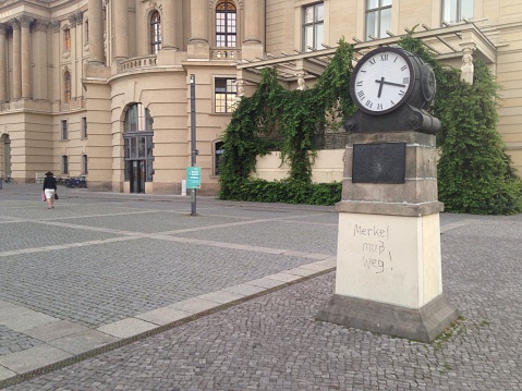 Berlin, Germany, 7th September 2016: A clock located in a square within the downtown area of Berlin.  Its pedestal has been written on.