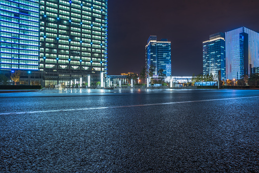 empty asphalt road with cityscape and skyline of Shanghai at night.