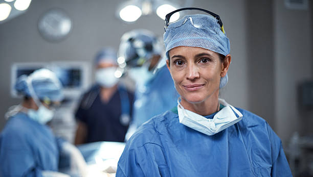 It's a beautiful day to save lives Portrait of a surgeon looking happy in an operating room surgeon stock pictures, royalty-free photos & images