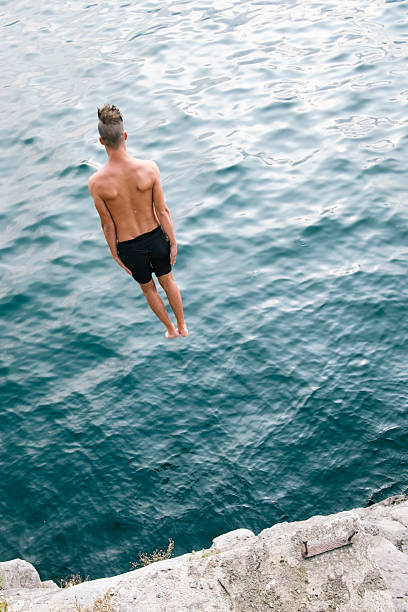 istock Jump in the water, Young man diving 603267940