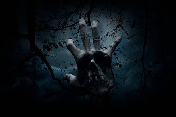 istock Hand blend with human skull over dead tree, Halloween concept 603269414