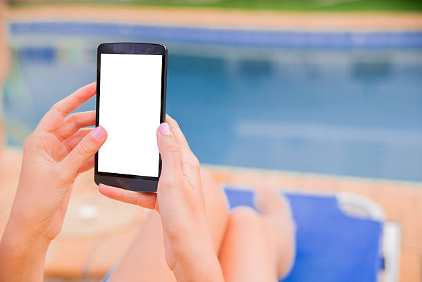 istock Woman sitting in deck chair and using mobile phone 603271446