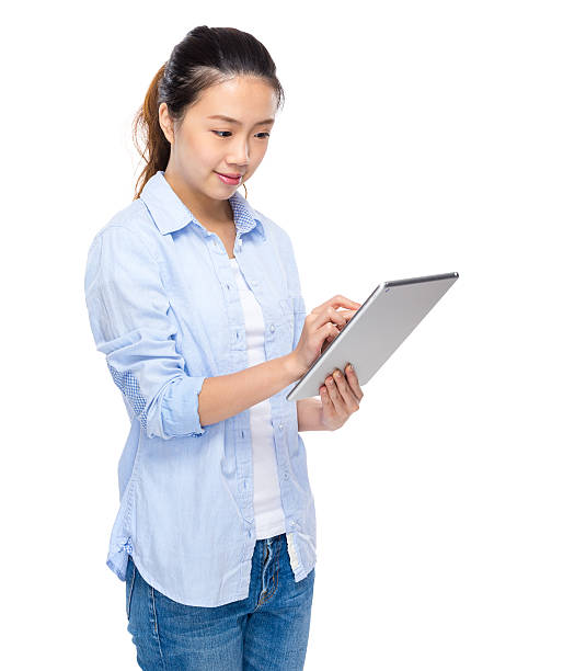 istock Chinese woman holding a tablet 603273712