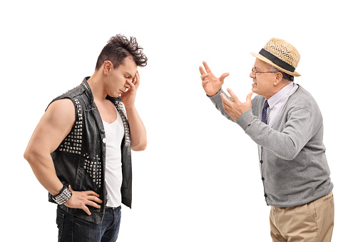 Young punker having an argument with a senior isolated on white background