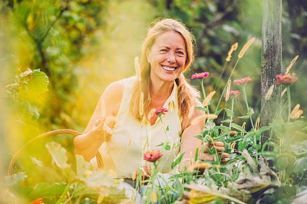 istock Happy Senior Woman Checking her Flowers 603276510