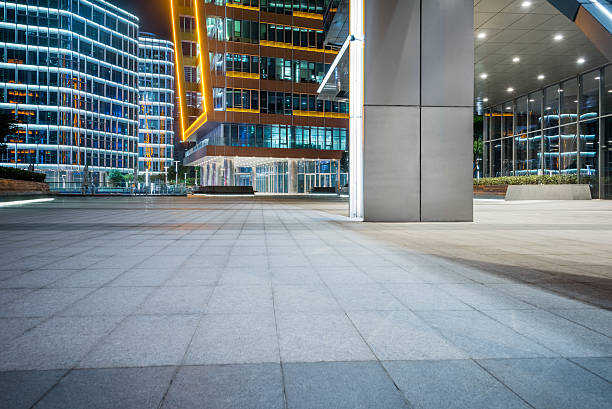istock night view of empty brick floor front of modern building 603276916