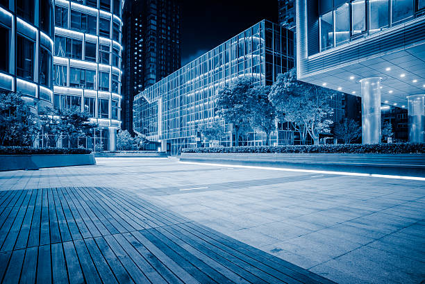 istock night view of empty brick floor front of modern building 603277094