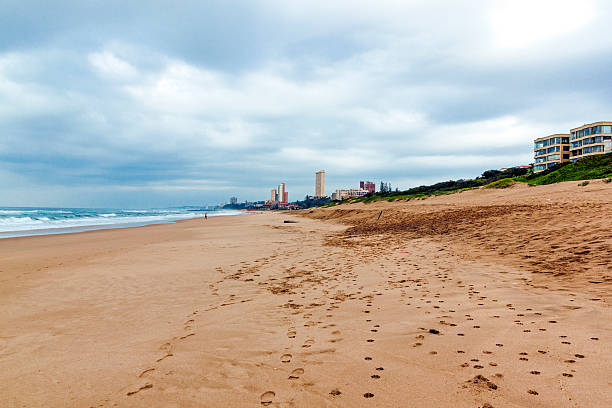 istock Empty Beach Against Cty Buildings and Overcast gloomy Skyline 603278768