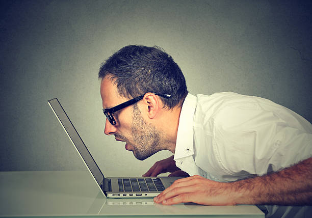 istock man staring closely intensely at laptop screen 603278994