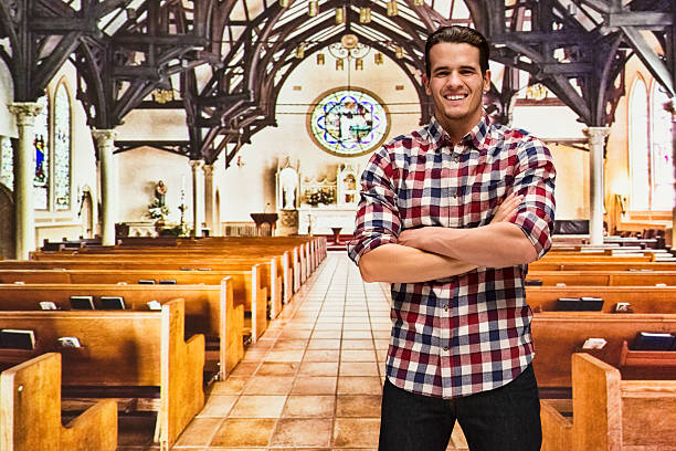 istock Smiling male standing in church 603281116