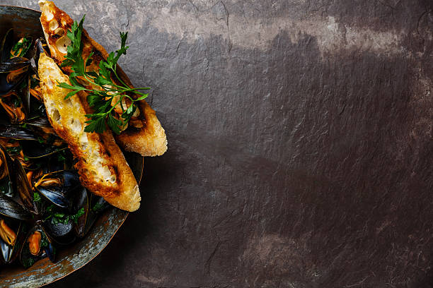 istock Mussels and toasts on slate background 603281866