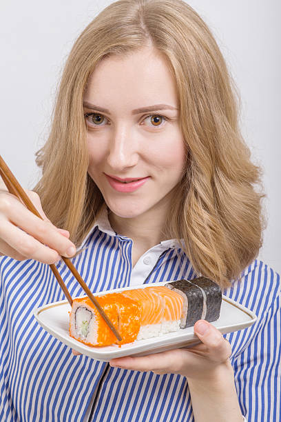 istock woman with sushi 603283692