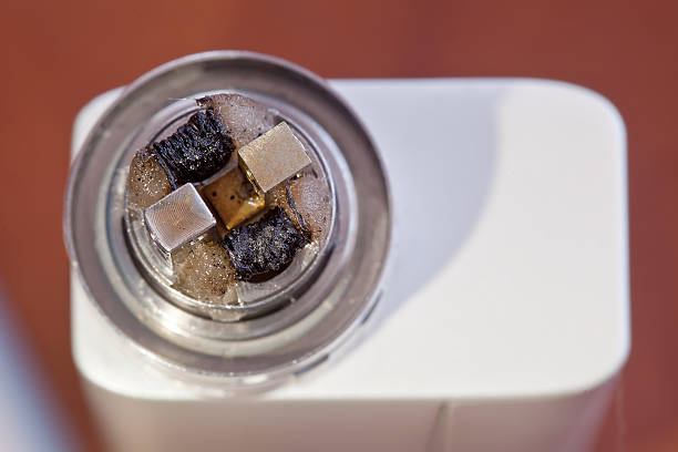 istock Dirty twisted coil mounted in the electronic cigarette 603283764