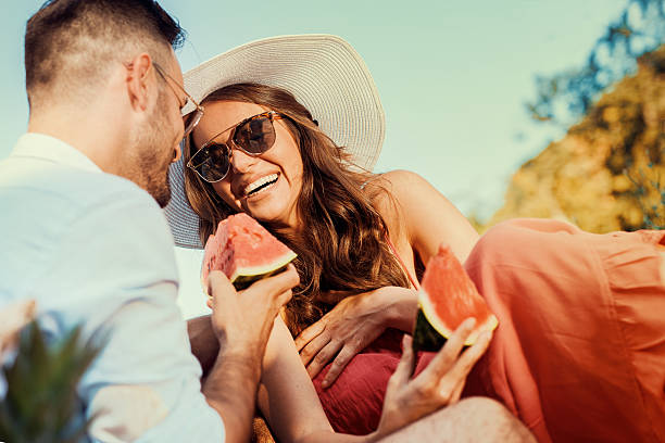 istock Laughing couple having picnic in countryside 603283980