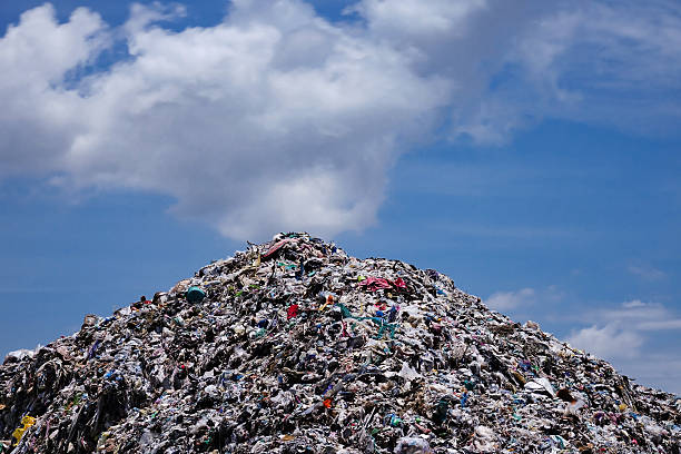 Landfill with blue sky and cumulus clouds Landfill with blue sky and cumulus clouds, garbage dump in the nature garbage dump stock pictures, royalty-free photos & images