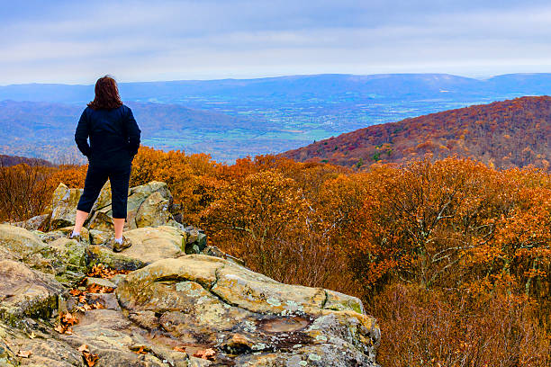 istock Mature woman looking over an autumn scene 603286002