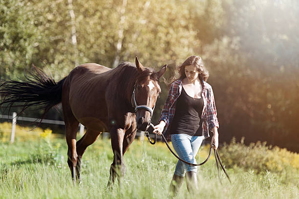 istock Young woman with horse 603287670