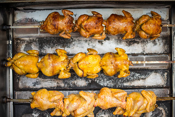 Delicious rotisserie chicken at various stages of cooking, Sitges, Spain
