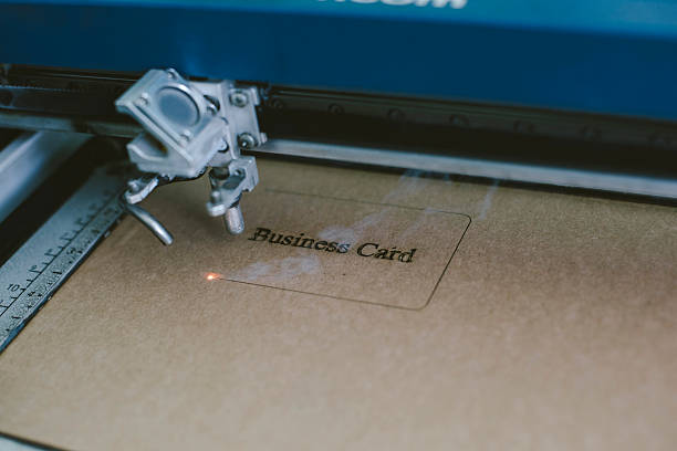 istock Laser engraving business card from recycled cardboard 603288420