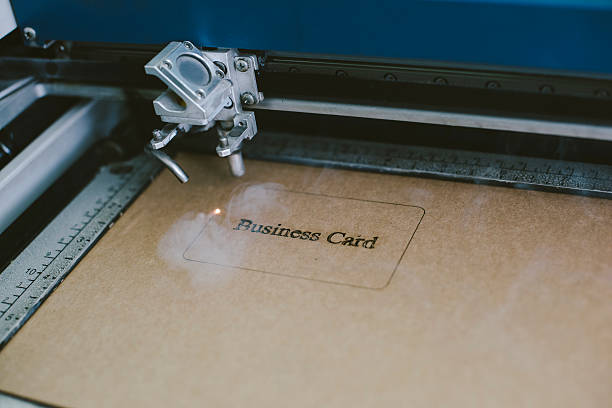 istock Laser engraving business card from recycled cardboard 603288470