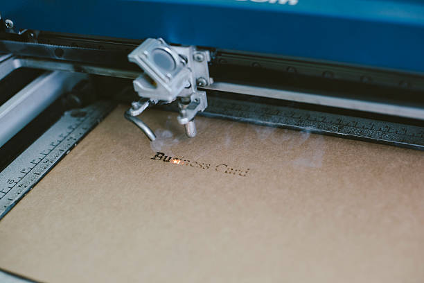 istock Laser engraving business card from recycled cardboard 603288492