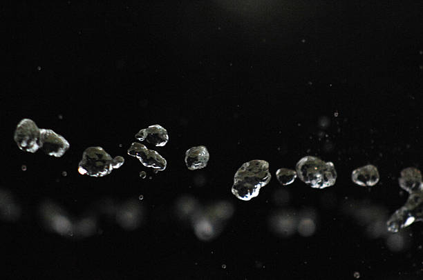 istock Water drops levitating in the air in dark. Splashing 603290116
