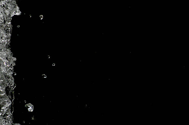 istock Water drops levitating in the air in dark. Splashing 603290810