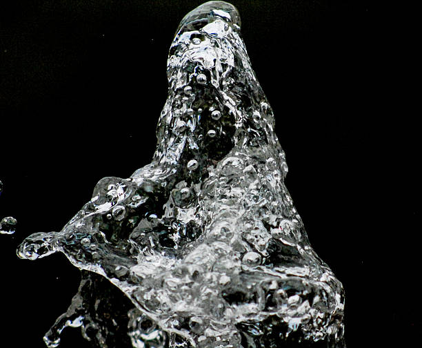 istock Water drops levitating in the air in dark. Splashing 603291064
