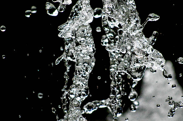 istock Water drops levitating in the air in dark. Splashing 603291422